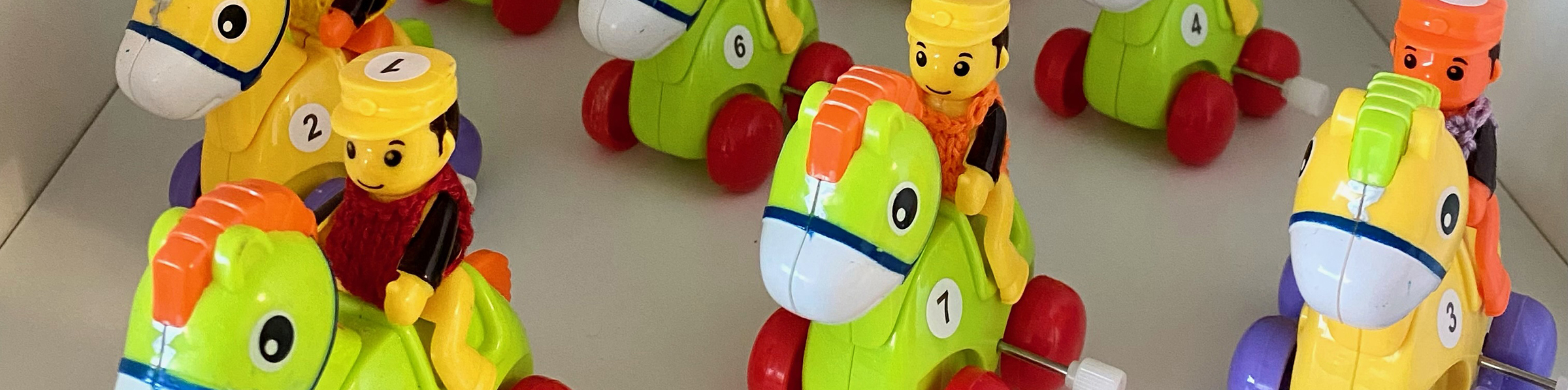a row of wind-up toy horses